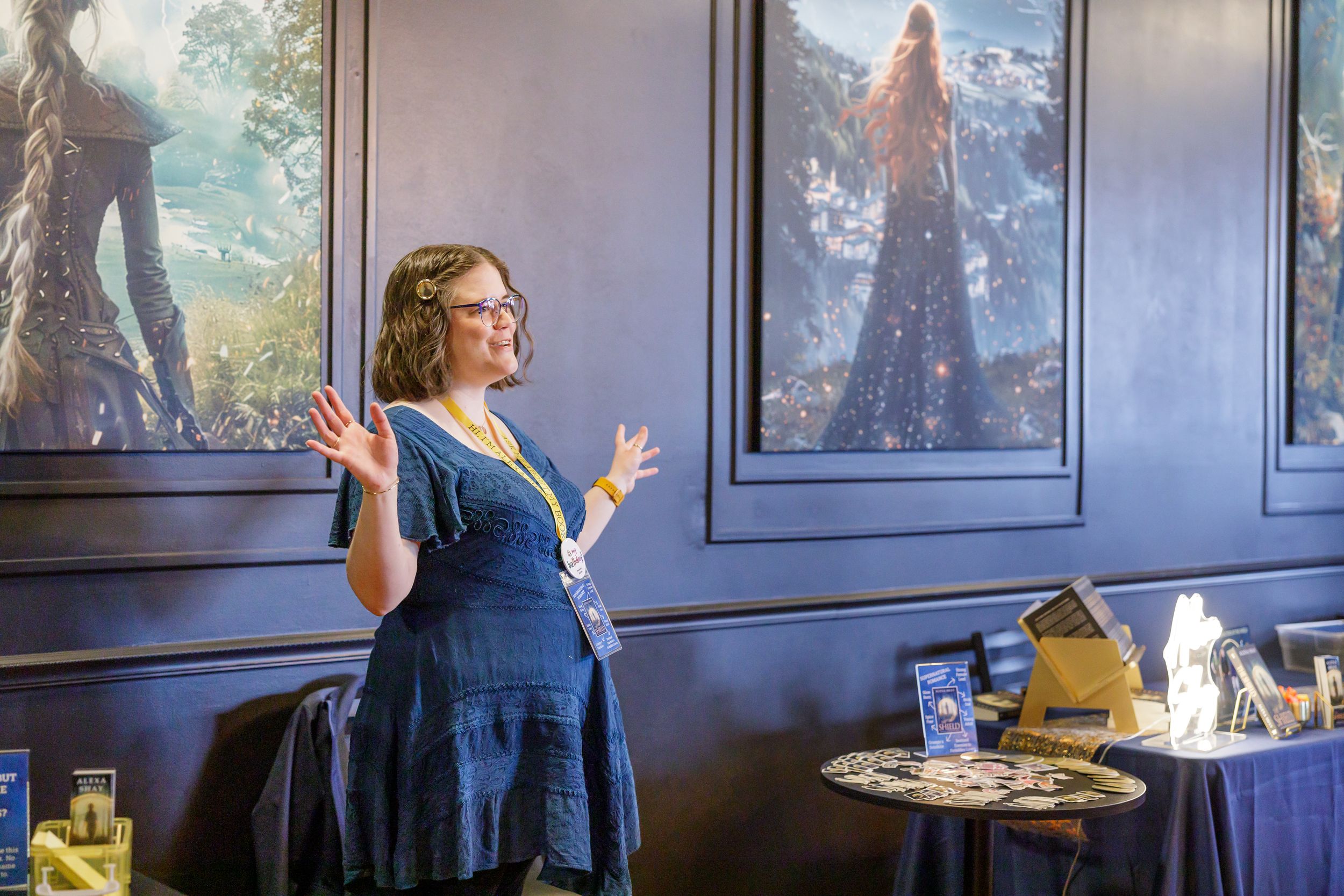indie book author Alexa Shay author signing event in Seattle, WA bookstore standing by table display talking answering questions of readers