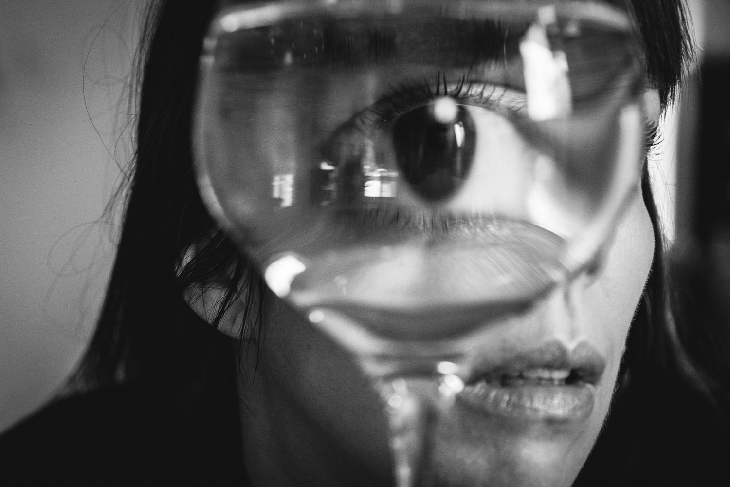 A creative black and white photo collage showing extreme close-ups of facial features including eyes, mouth and nose.