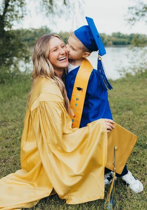 kindergarten cap and gown boy blue cap and gown sister senior girl  kiss on cheek