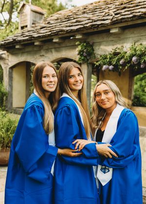 3 friends graduating blue gowns