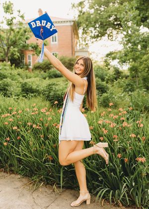 senior girl white dress blue cap and gown