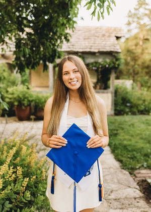 senior girl white dress blue cap and gown