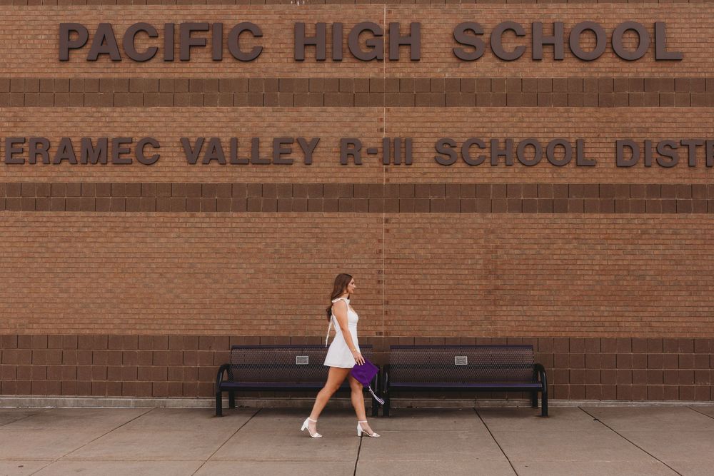 Graduate senior girl white dress purple cap and tassel and gown golden hour movement pacific high school