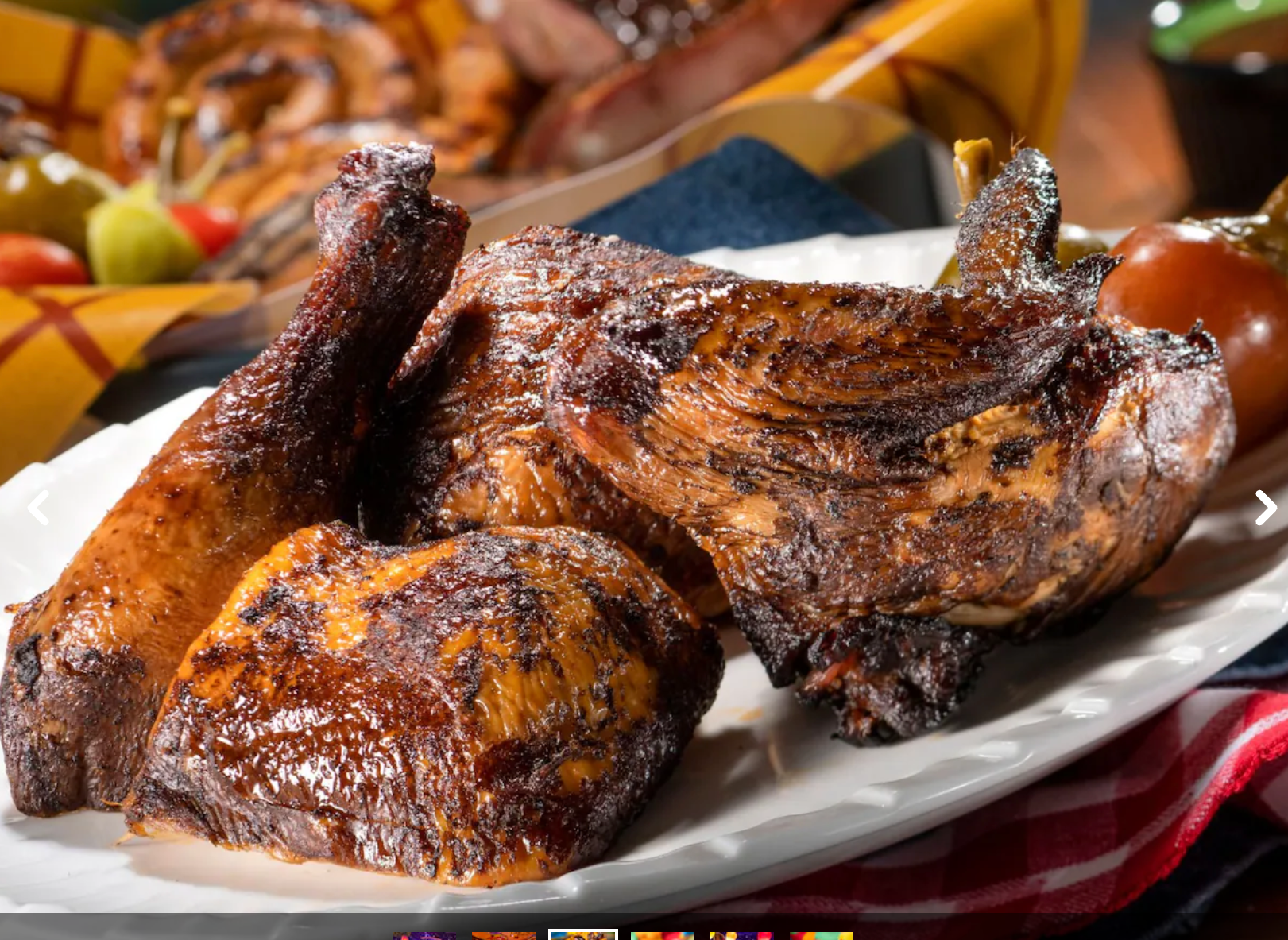 Grilled chicken or turkey legs with crispy browned skin served on white plates.
