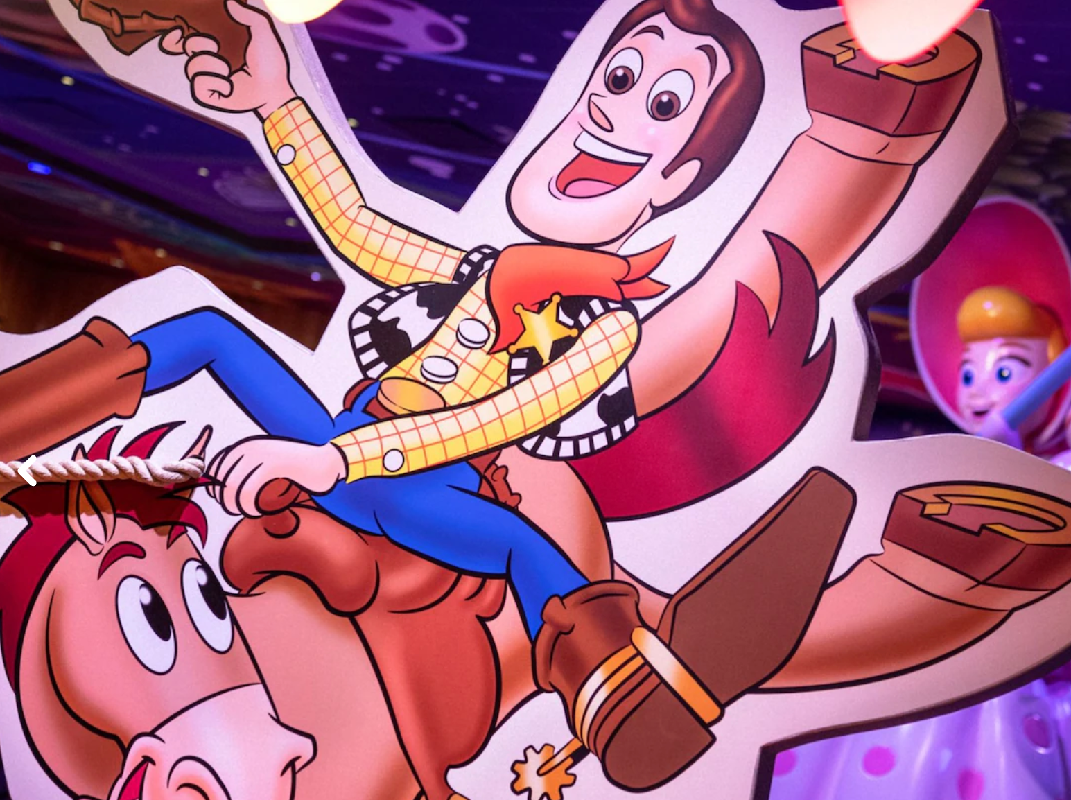 Animated characters from Toy Story in vibrant purple lighting.