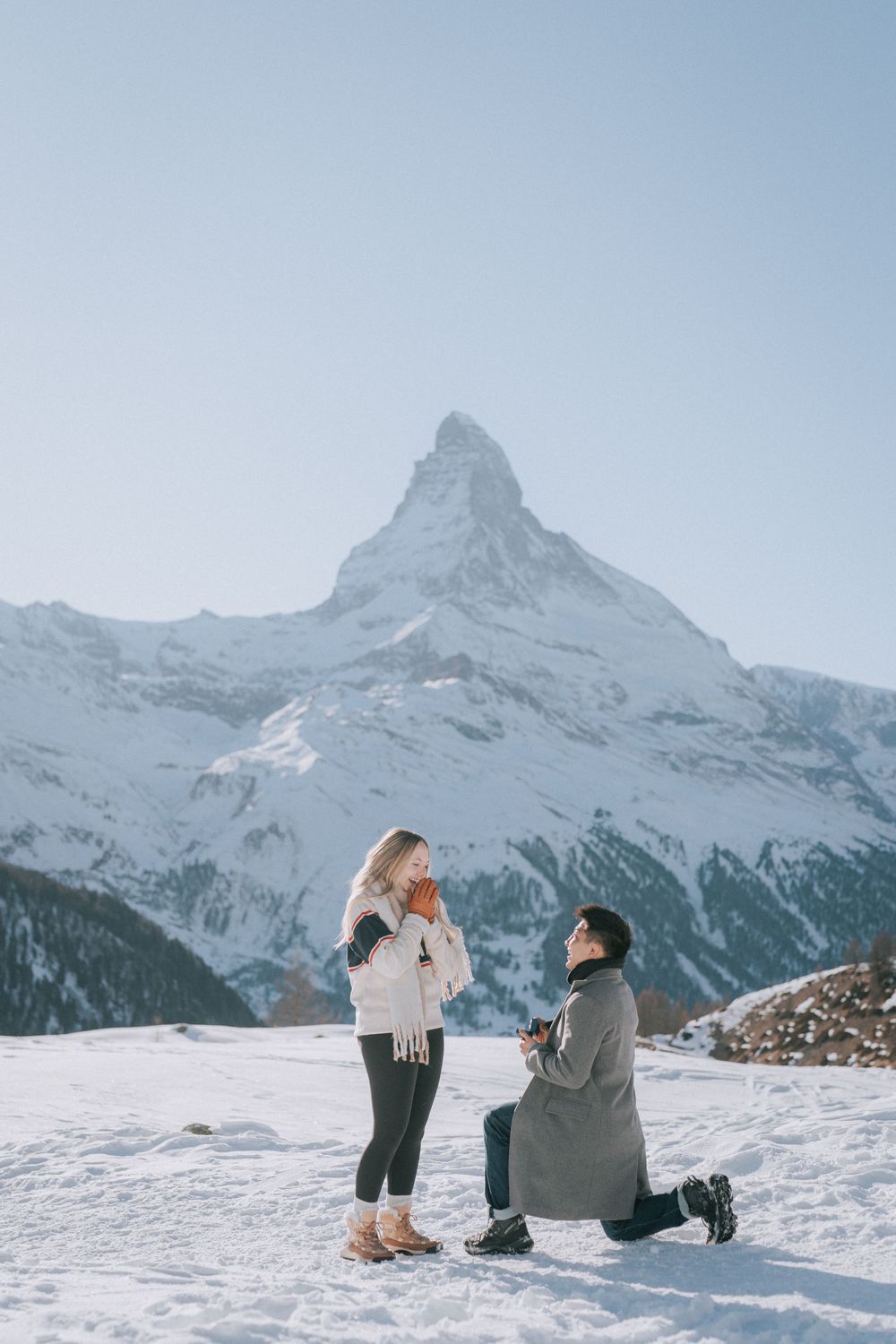 Marriage proposal in the snow with the iconic Matterhorn mountain peak in the background.