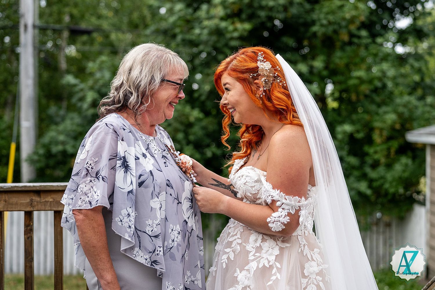 An emotional moment shared between people during an outdoor wedding ceremony.