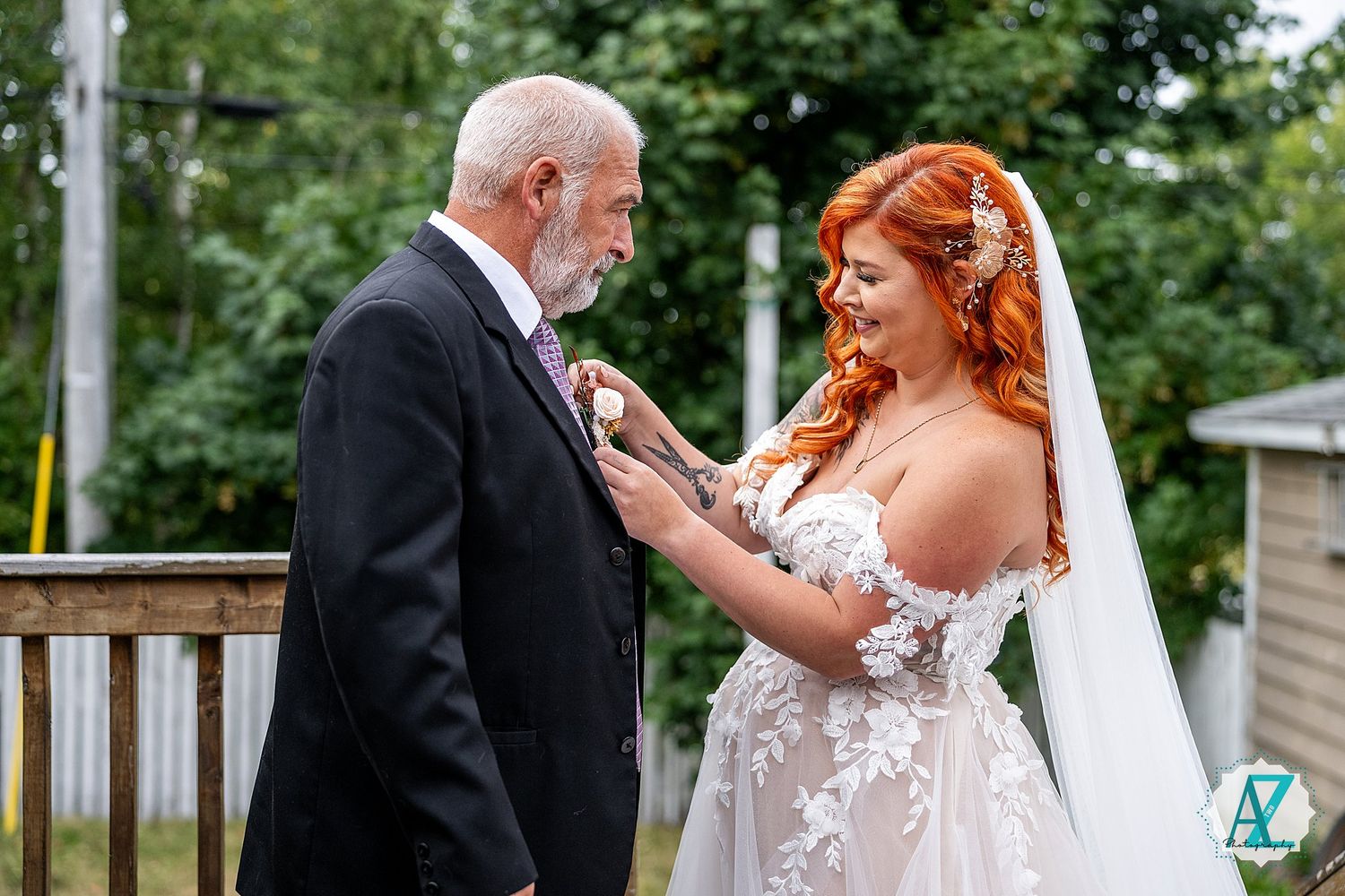 Emotional wedding ceremony moments on outdoor deck with natural greenery.