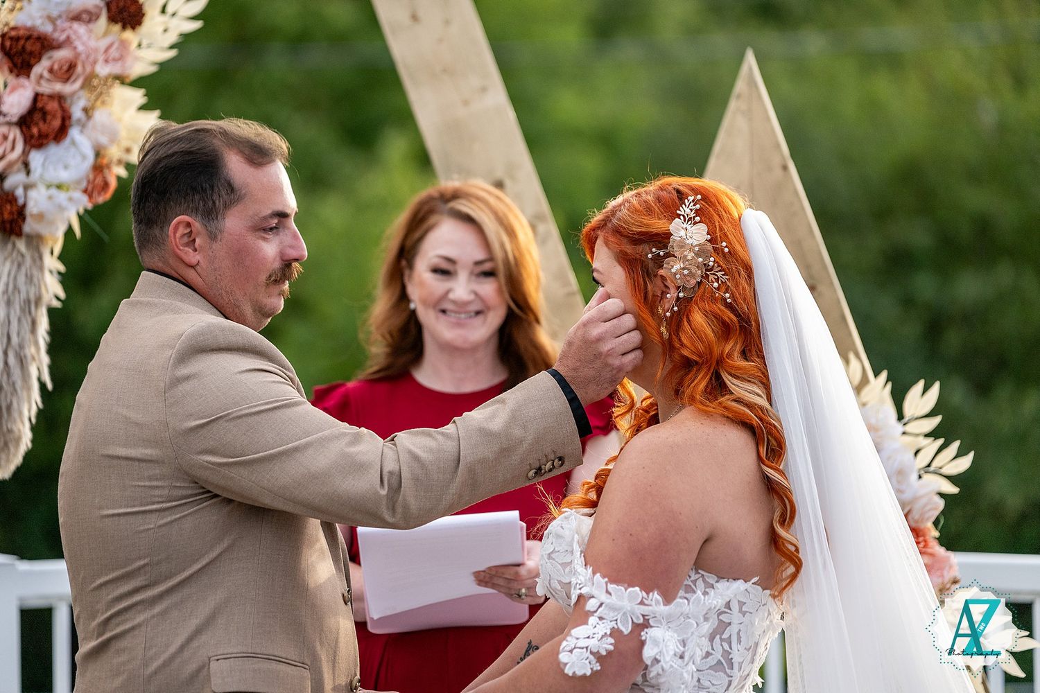 Joyful outdoor wedding celebration with burgundy and white color theme.