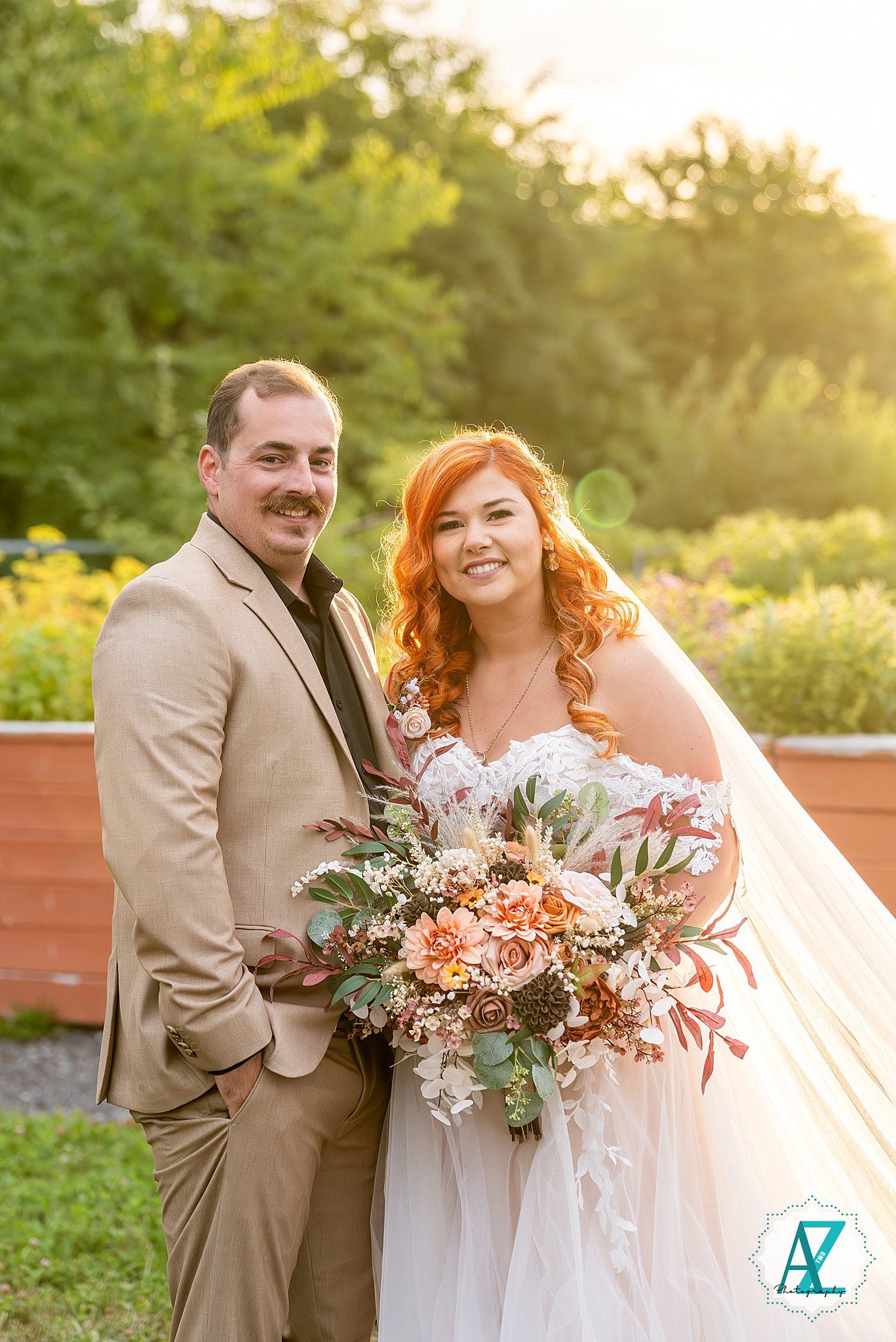 Romantic sunset wedding photography session with soft golden light and peach-colored floral bouquet.