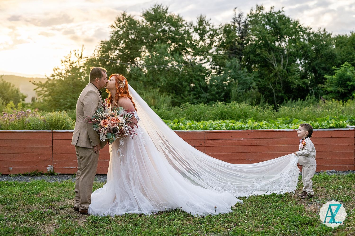 Wedding couple shares tender moments on wooden benches surrounded by greenery at golden hour.