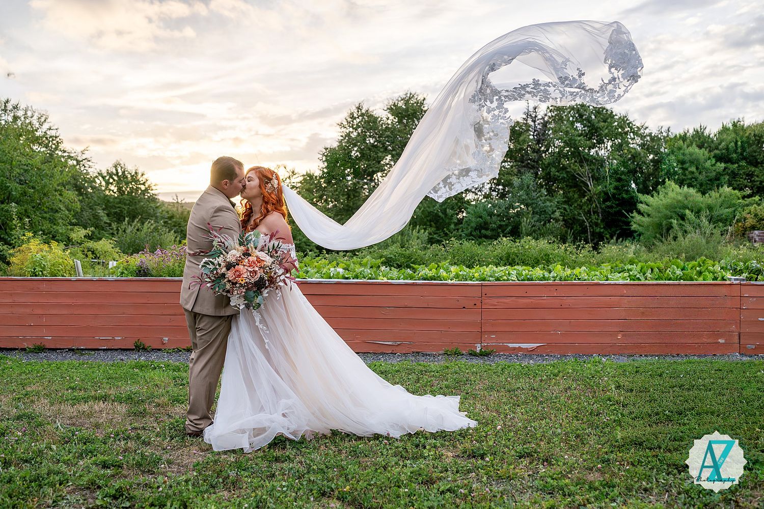 A romantic wedding moment captured in a lush green outdoor setting with an elegant white dress flowing in the breeze.
