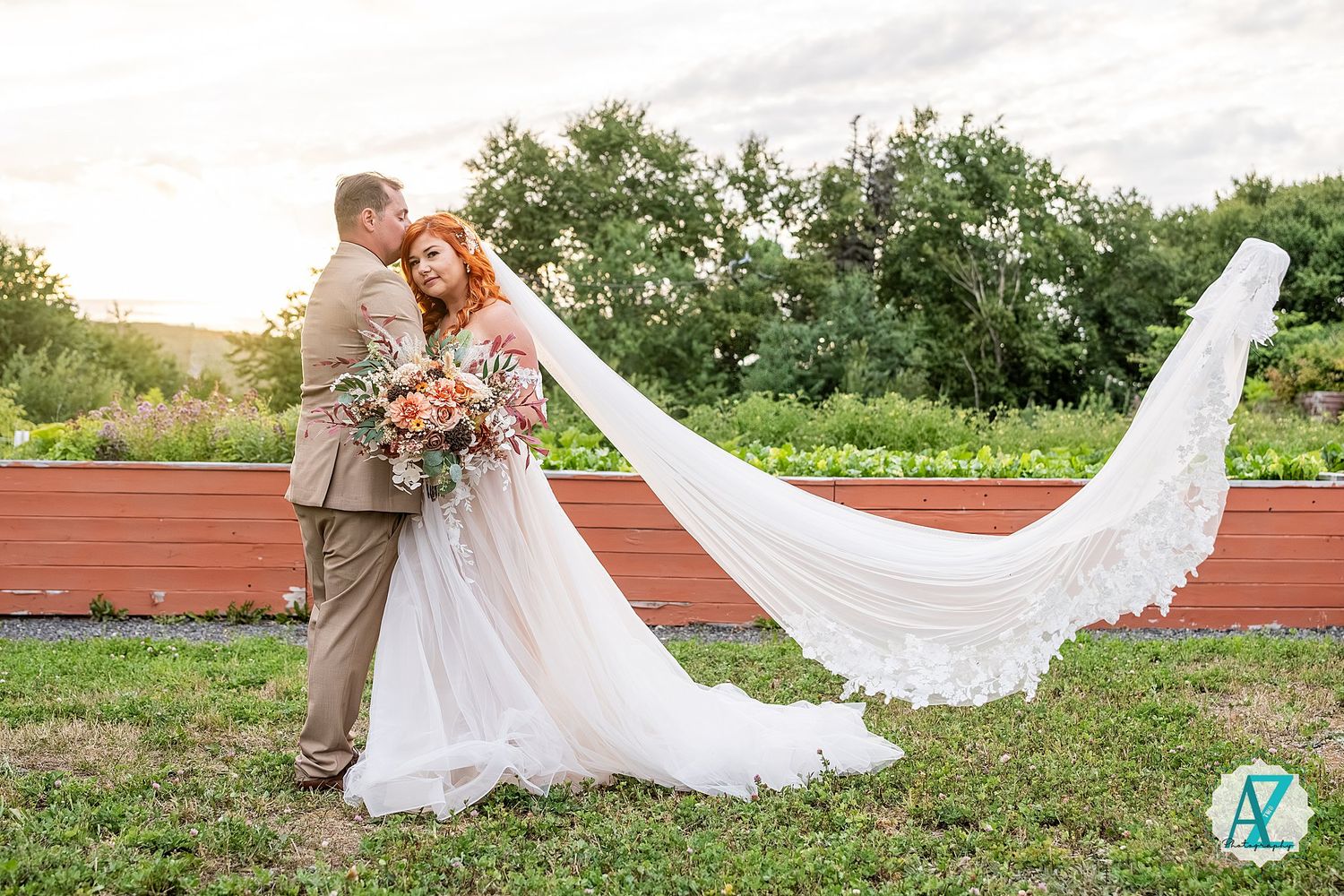 A dramatic white wedding veil floats elegantly in the breeze during an outdoor summer photo session.