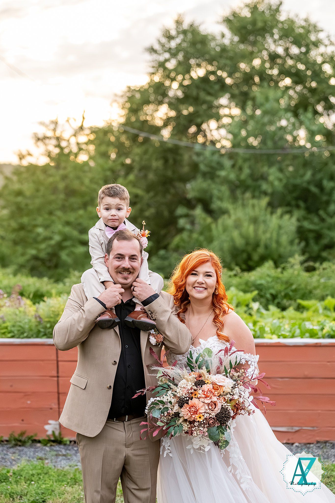Newlywed couple shares playful candid moments together during outdoor wedding photo session at sunset.