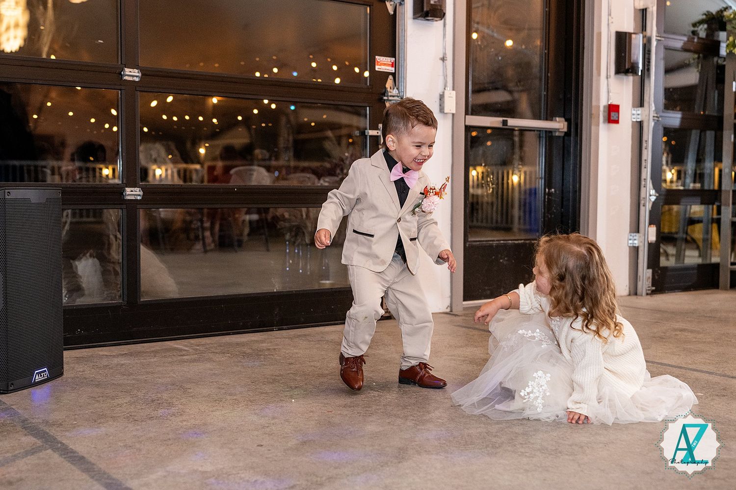 Dancing and celebrating at an evening wedding reception under string lights and modern decor.