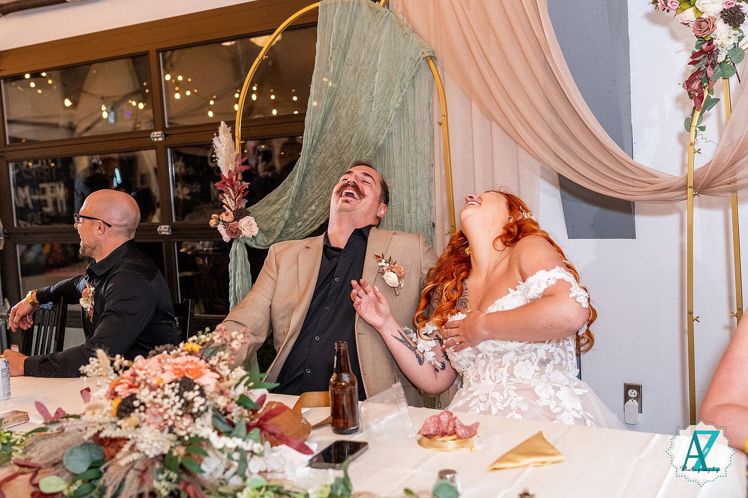 Candid moments of celebration at a wedding reception with soft pink decor and ambient lighting.