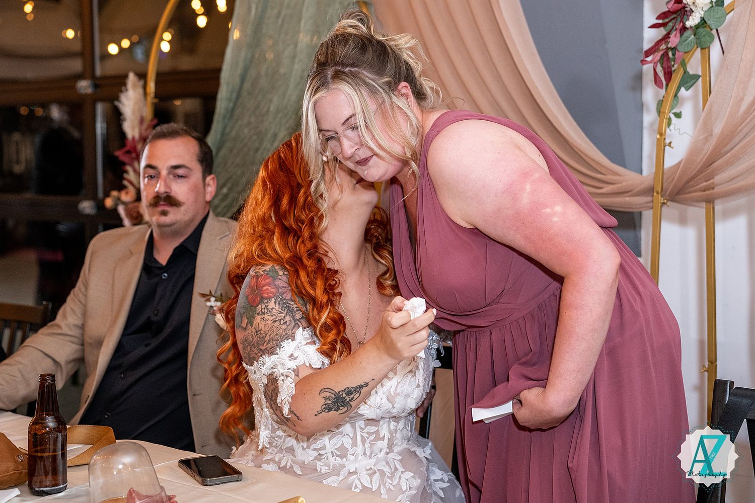 Wedding reception features guests in mauve dresses and festive party atmosphere.