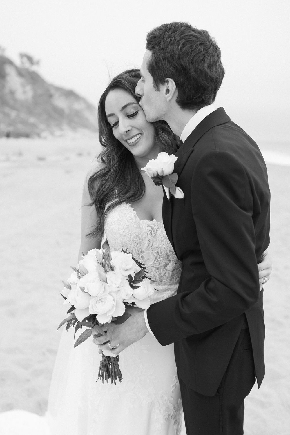 Black and white film portrait of a bride and groom on their Malibu wedding day.