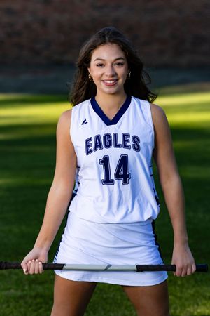 Athletic portrait series showing white uniform jerseys with blue numbers and 'Eagles' text against grass background.
