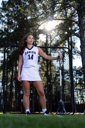 Dynamic sports photos against a backlit forest setting with soccer nets visible in the background.