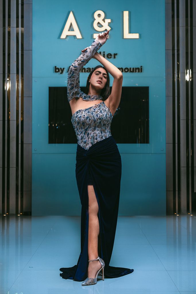 Fashion shoot against blue wall showing dance-inspired poses in evening wear.