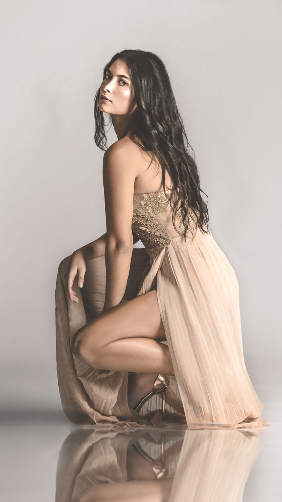 Artistic nude photography series with flowing beige fabric against minimalist background.