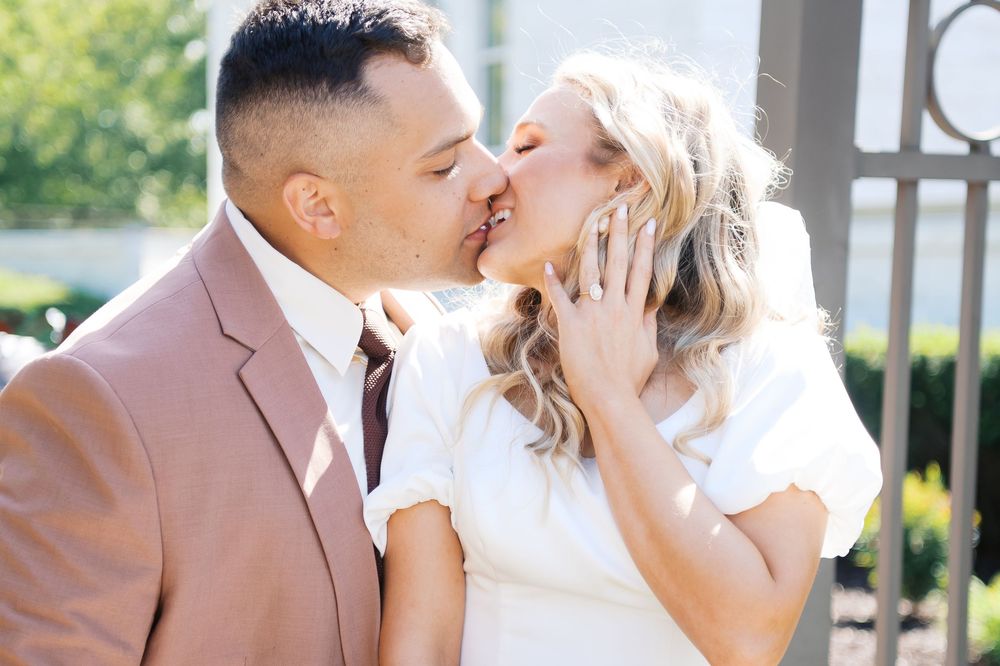 Couple shares a kiss during outdoor golden hour wedding photoshoot and the Nashville Tennessee LDS Temple, by Fayetteville NC Photographer