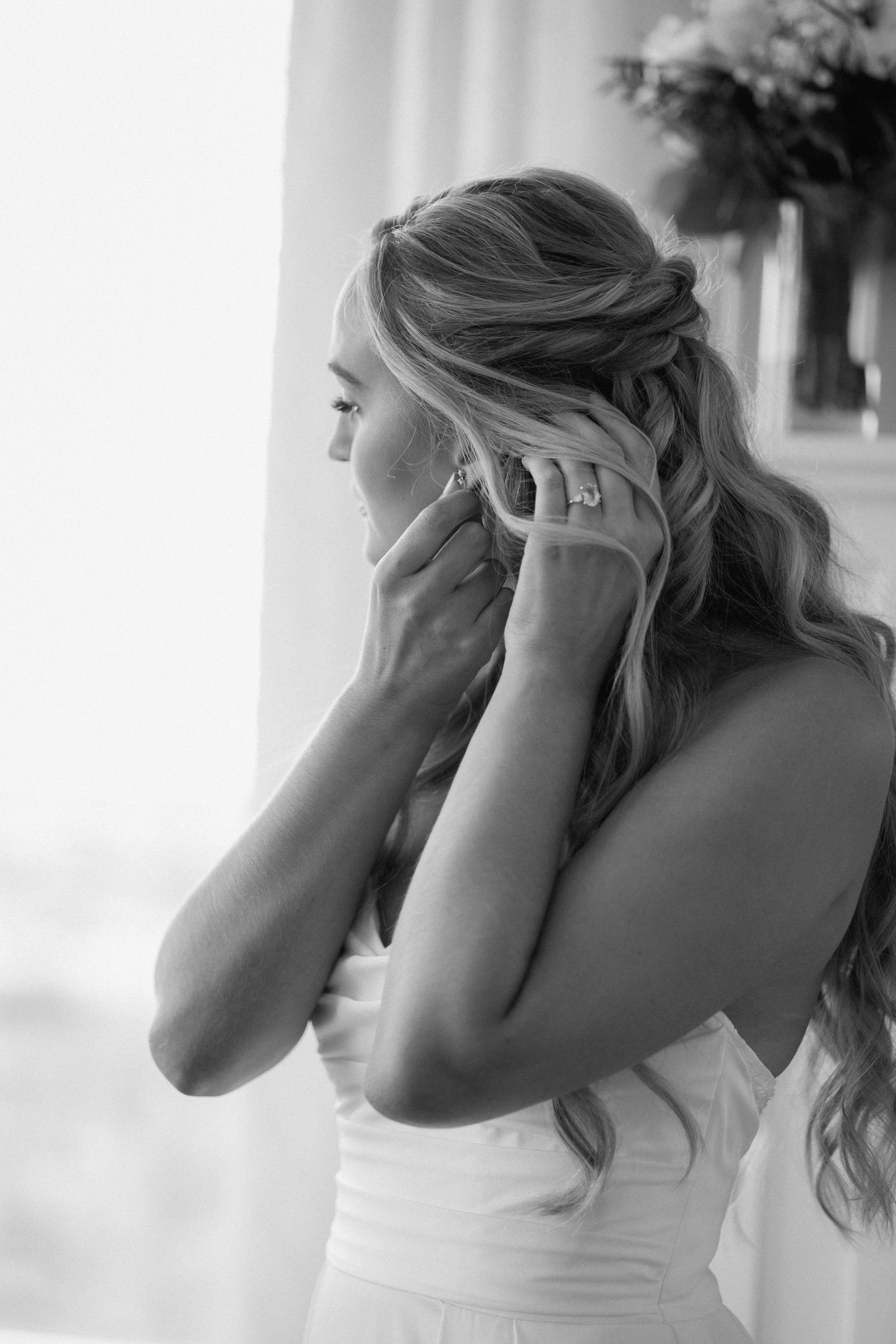 A series of three black and white photos showing a bride expressing joyful emotions in a white gown.