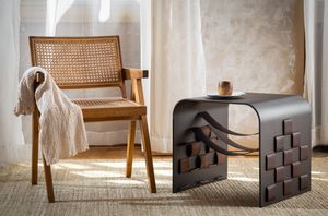 Neutral-toned cane back chairs and modern furniture pieces arranged in a minimalist interior setting.