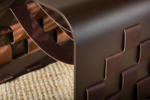 Close-up view of a braided leather watch band showing rich brown color and intricate weave pattern.