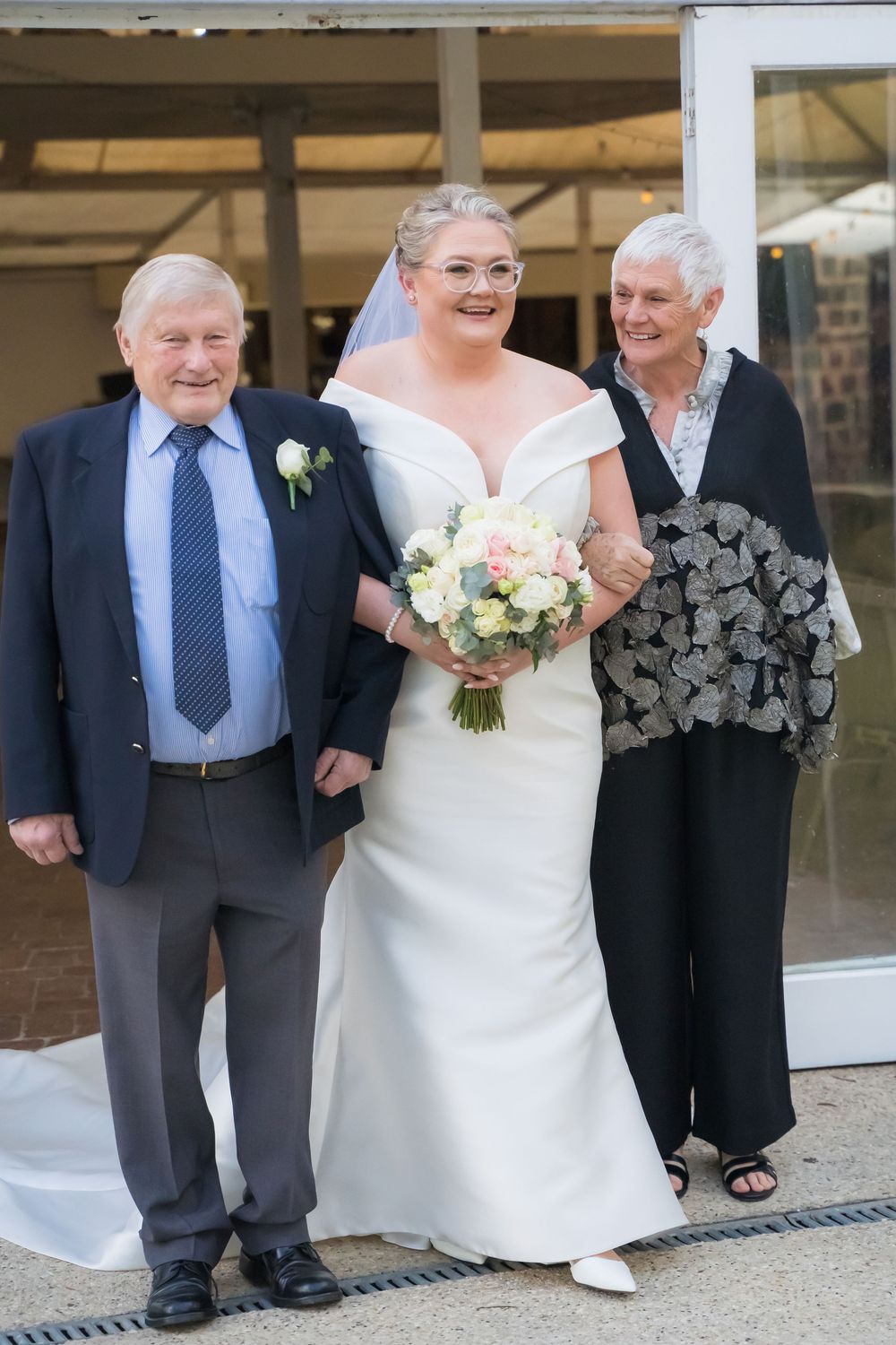 A series of four wedding photos showing the bride in a white dress walking with older relatives.
