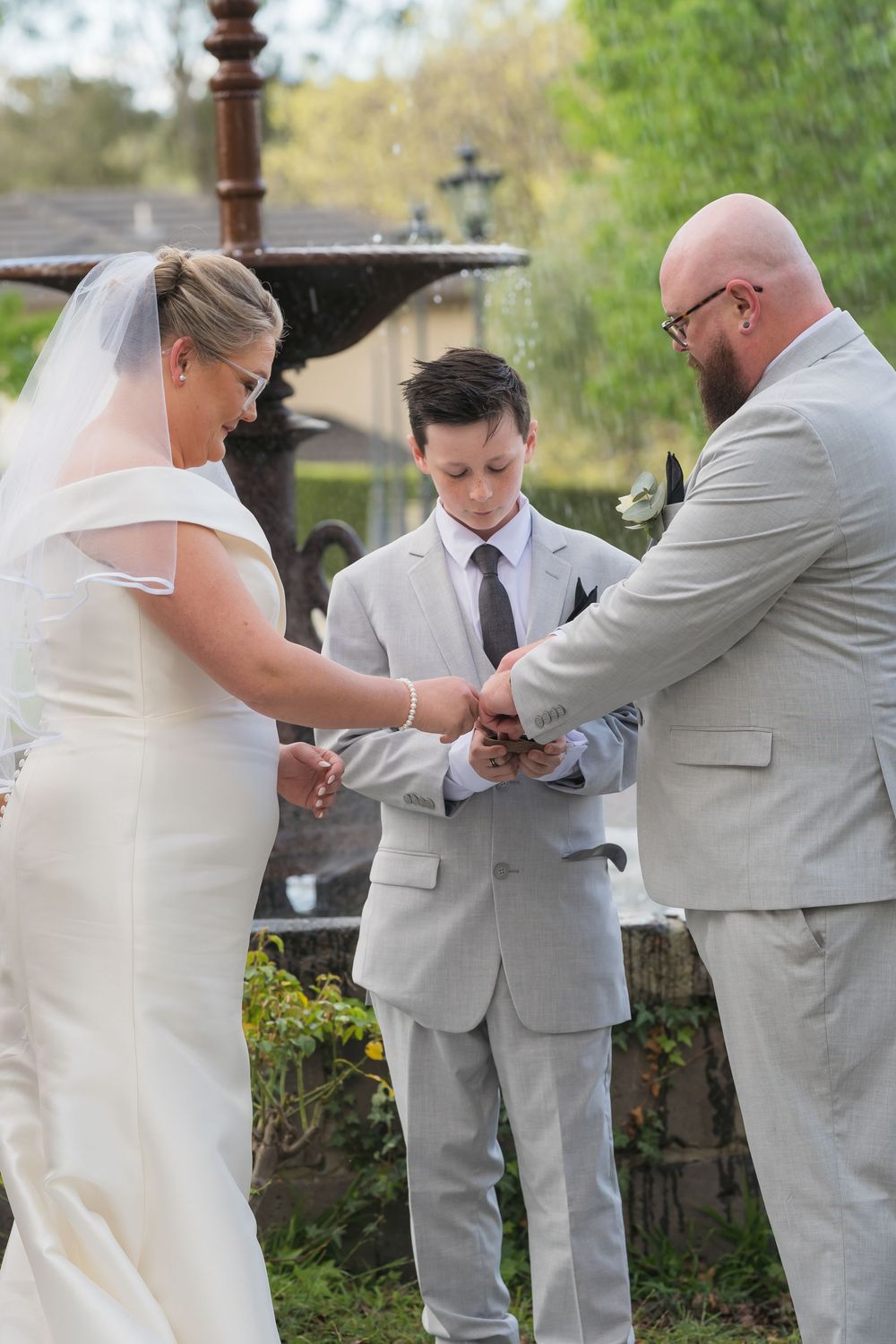 Series of wedding photos showing multiple people wearing gray suits and white dress in a receiving line outdoors.