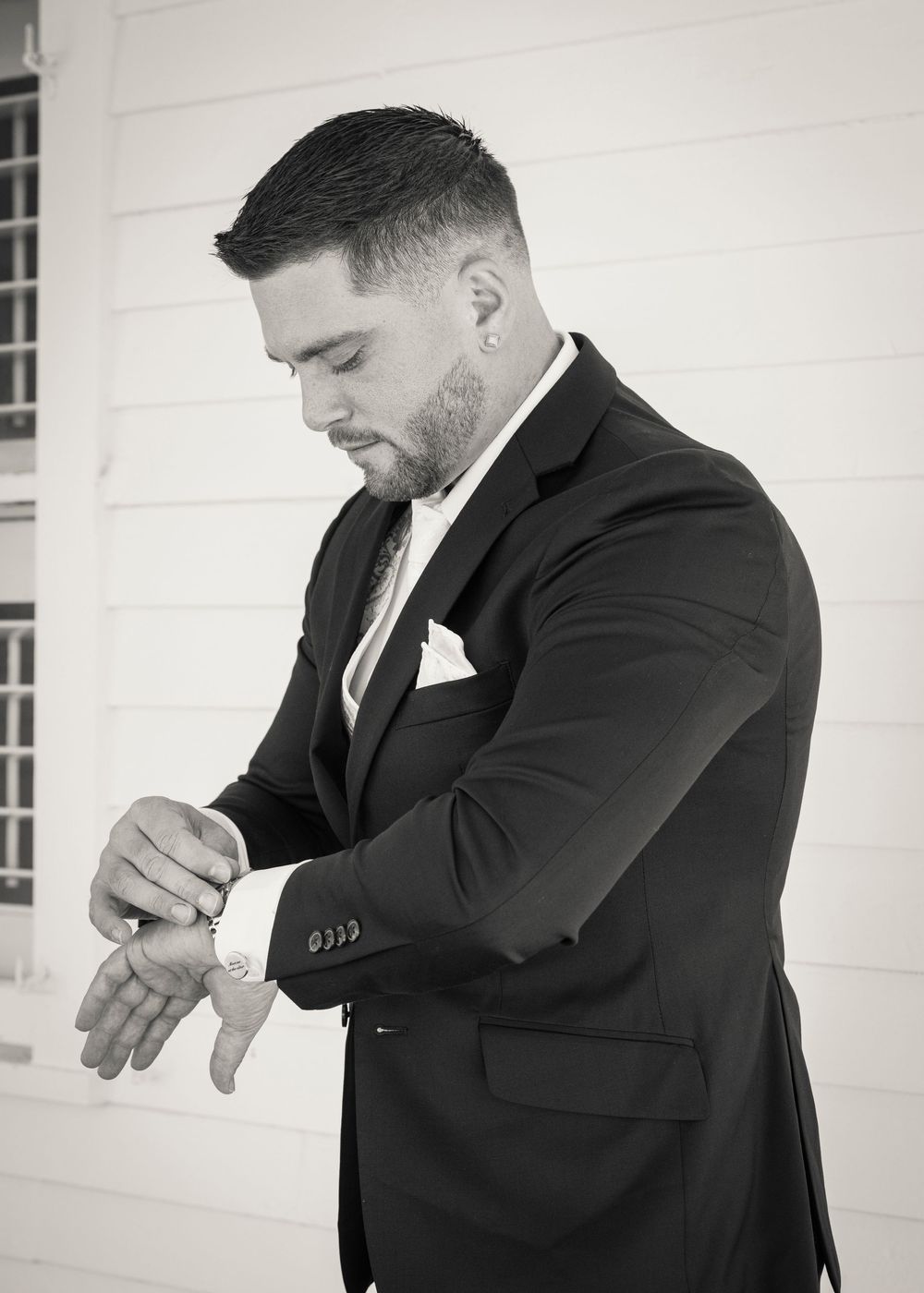 A sequence of photos shows someone in a black suit checking their wristwatch in various gestures against a white background.