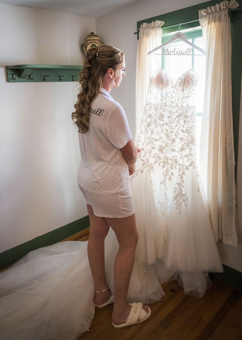 Candid series of getting ready scenes by window in white shirt and lace dress with natural lighting.