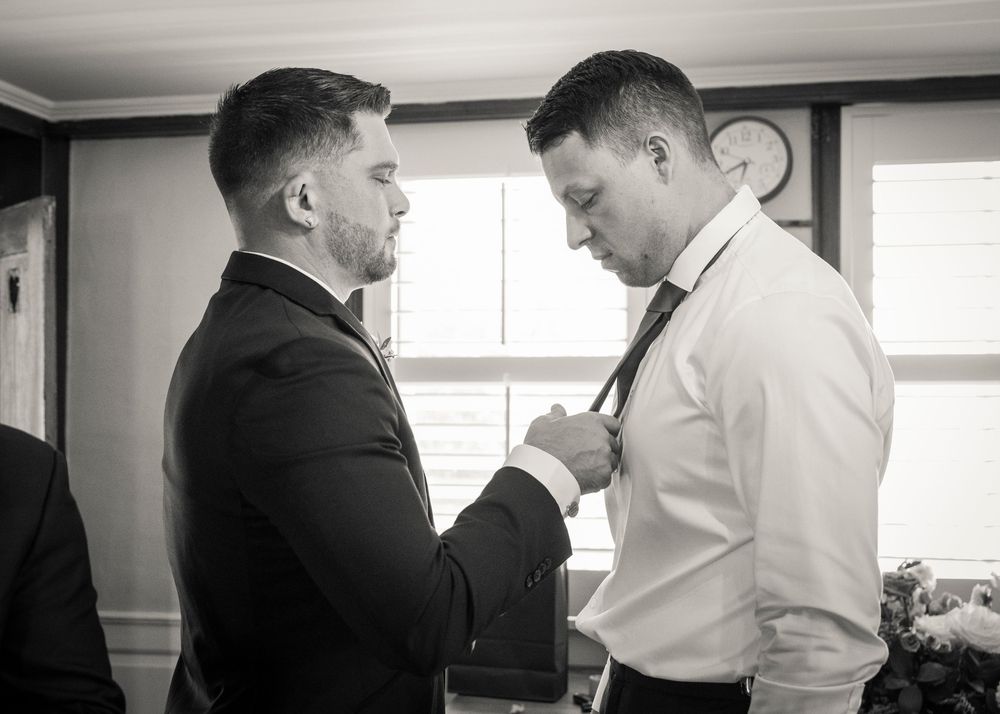 Wedding preparations in progress showing formal attire and getting ready in a bright indoor space.