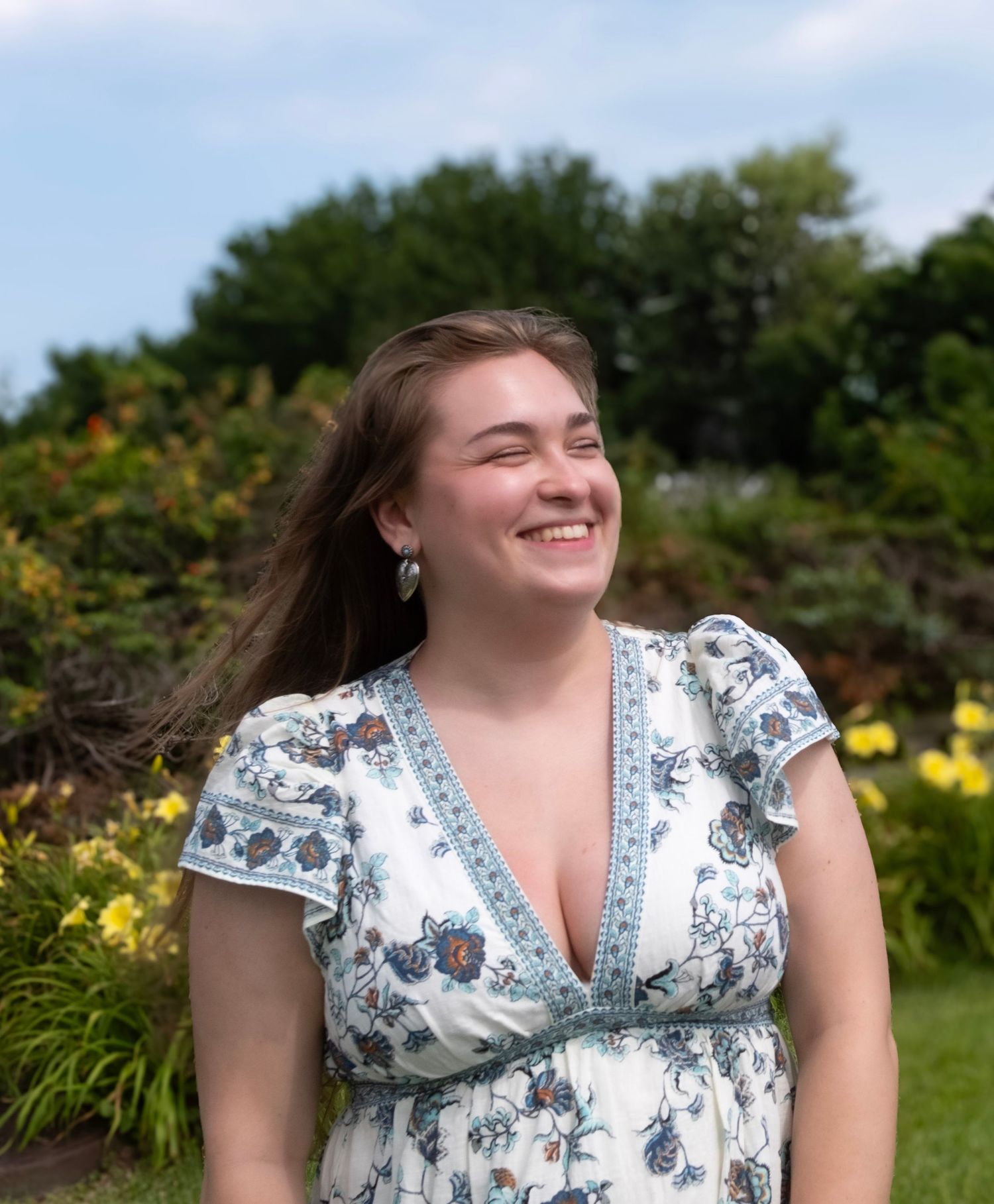 A candid moment of happiness captured in a garden with yellow flowers blooming.