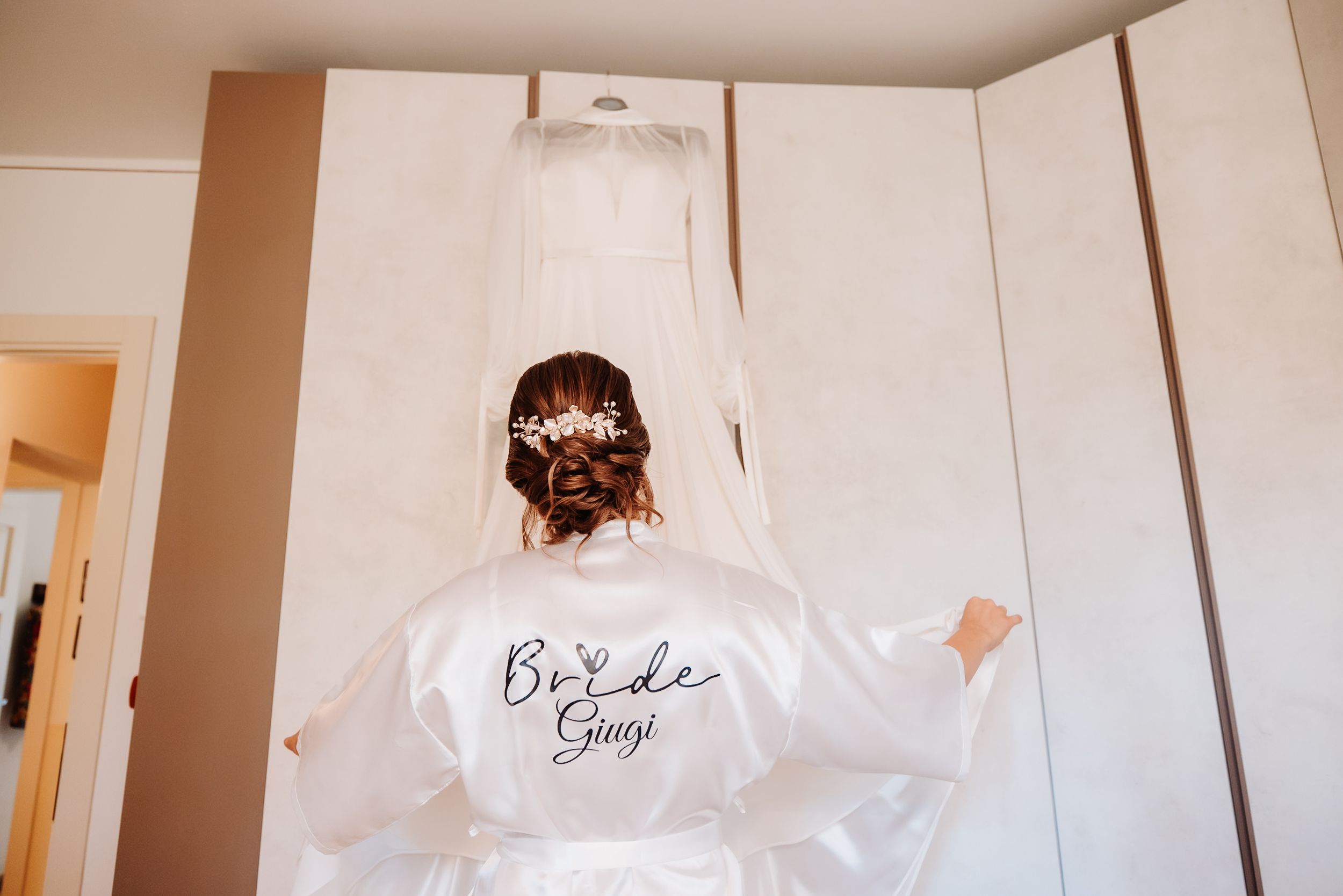 A collage of four images showing a white wedding dress hanging in different angles and lighting conditions.