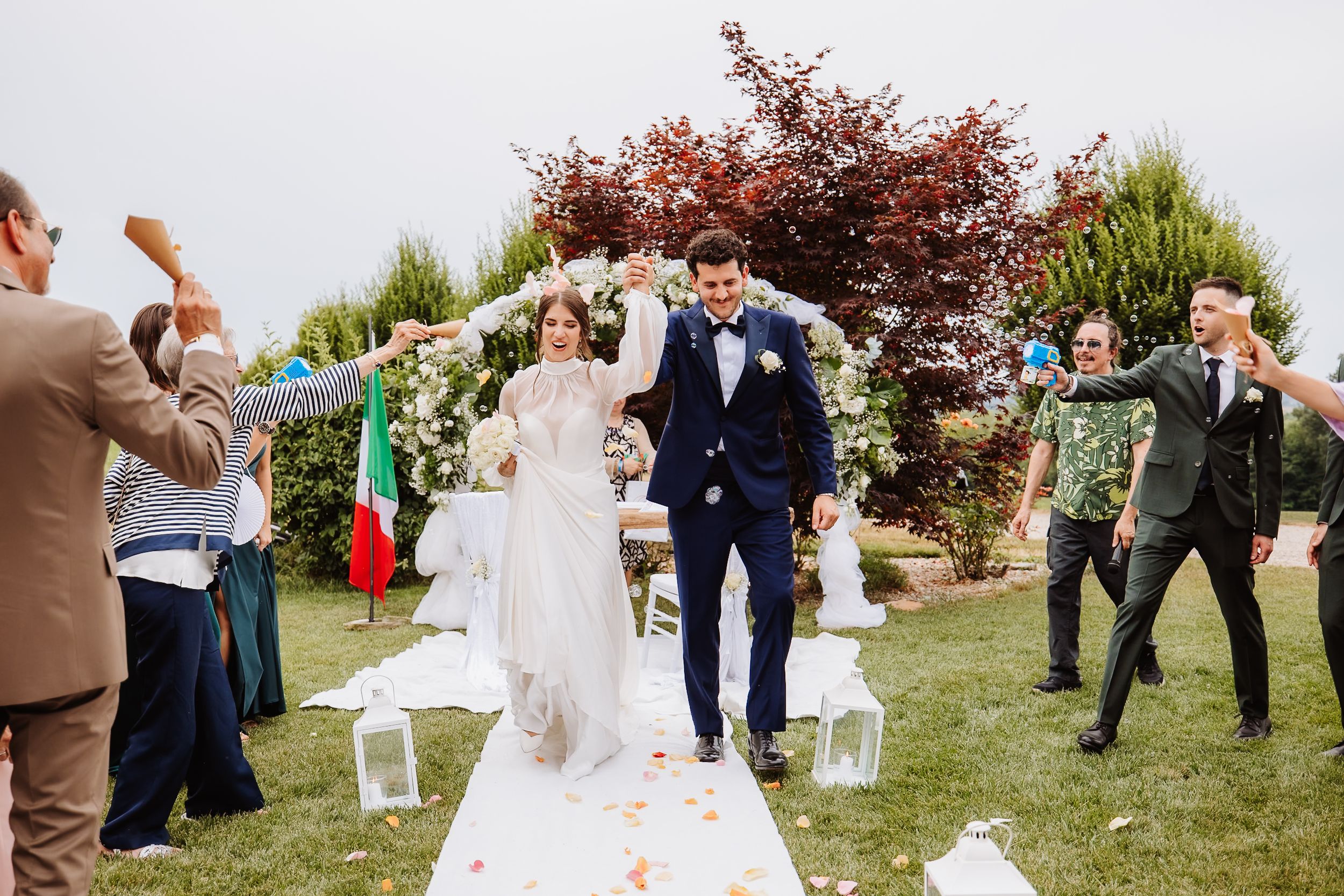 Panoramic sequence of guests celebrating and dancing outdoors at a rustic countryside wedding reception.