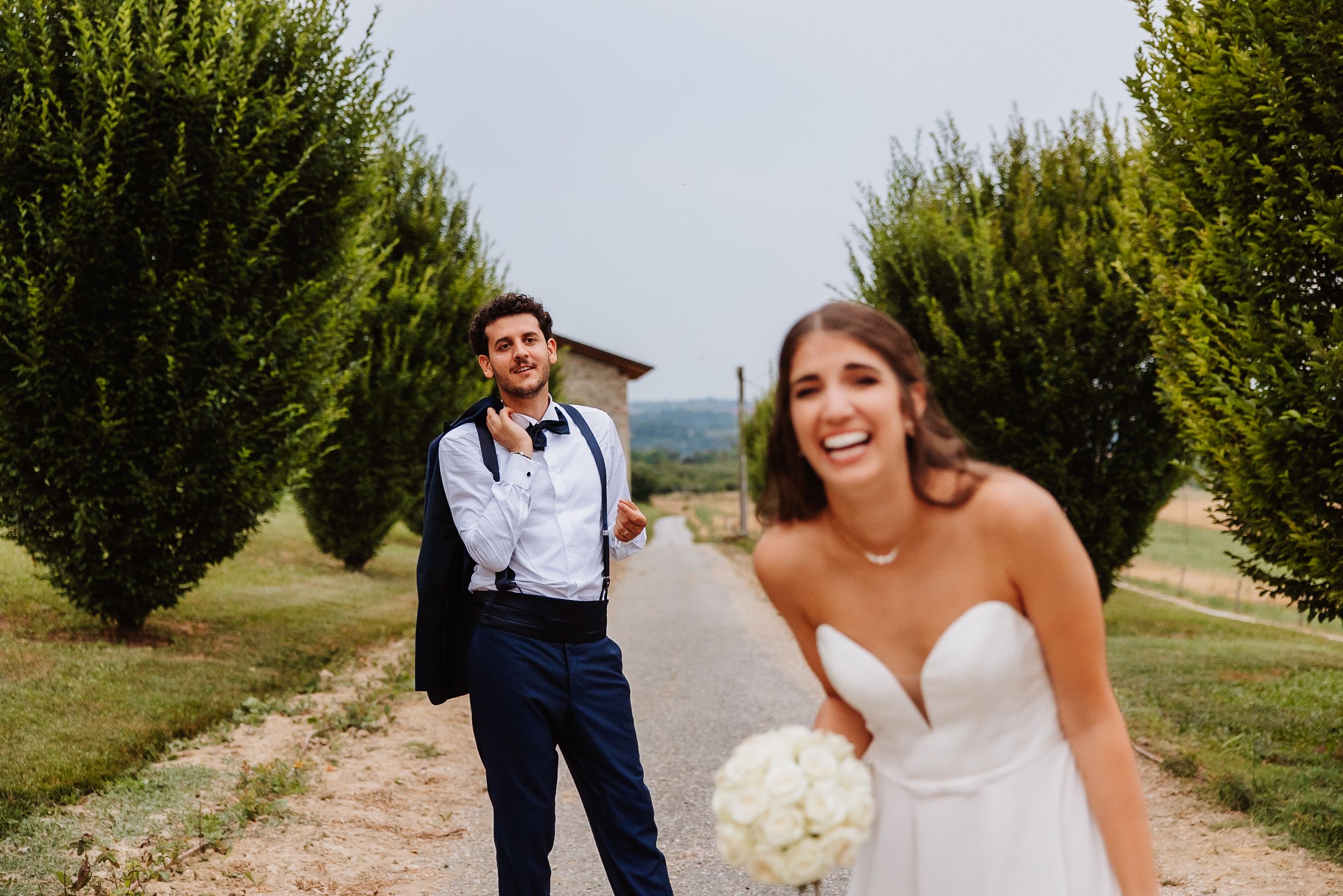 A wedding couple walks and dances through an orchard on their special day, creating joyful moments together.