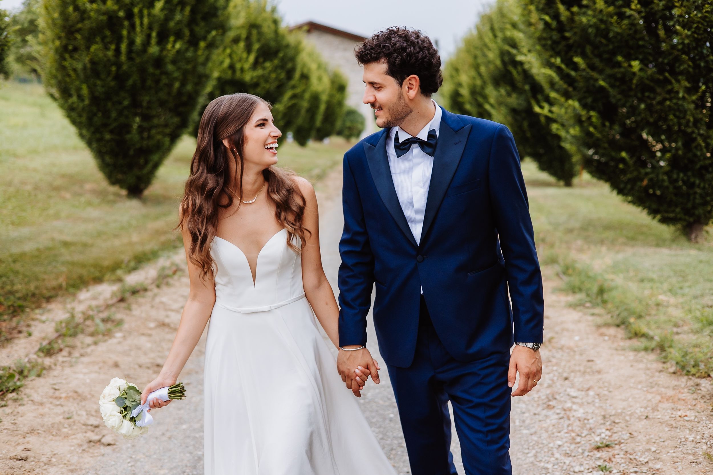 Collage of five wedding photos showing bride and groom walking together outdoors in romantic countryside setting.