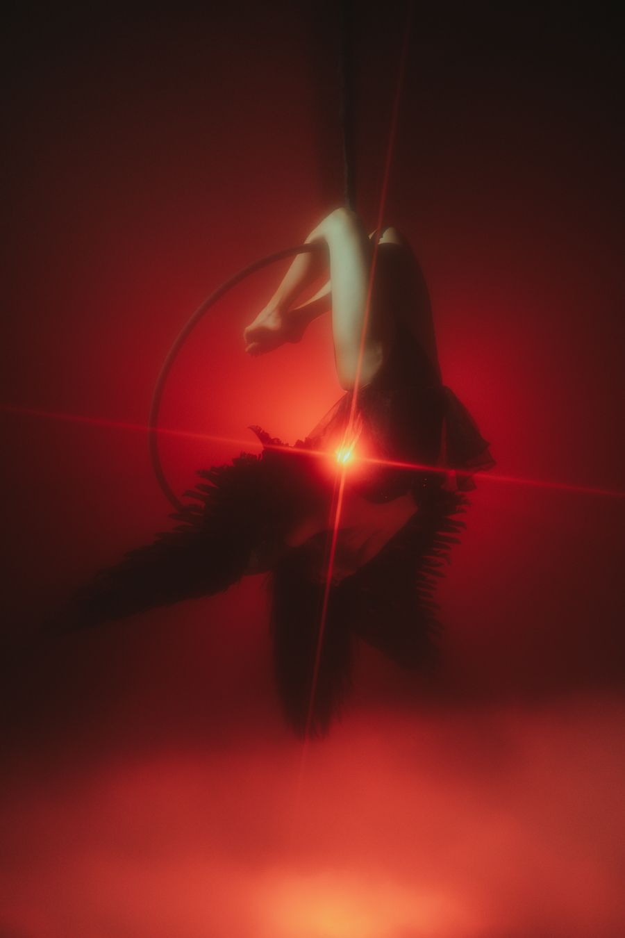 Dynamic aerial artist in motion, red backlight highlights strength and grace, Mannyportraits Miami performance and cinematic portraiture.