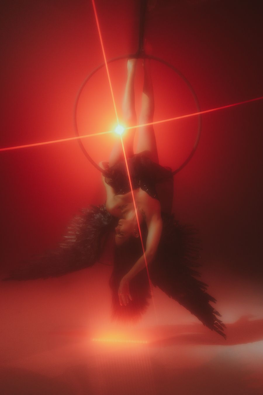 Aerial artist in red spotlight, cinematic photography capturing movement and power, Mannyportraits Miami South Florida performance shot.
