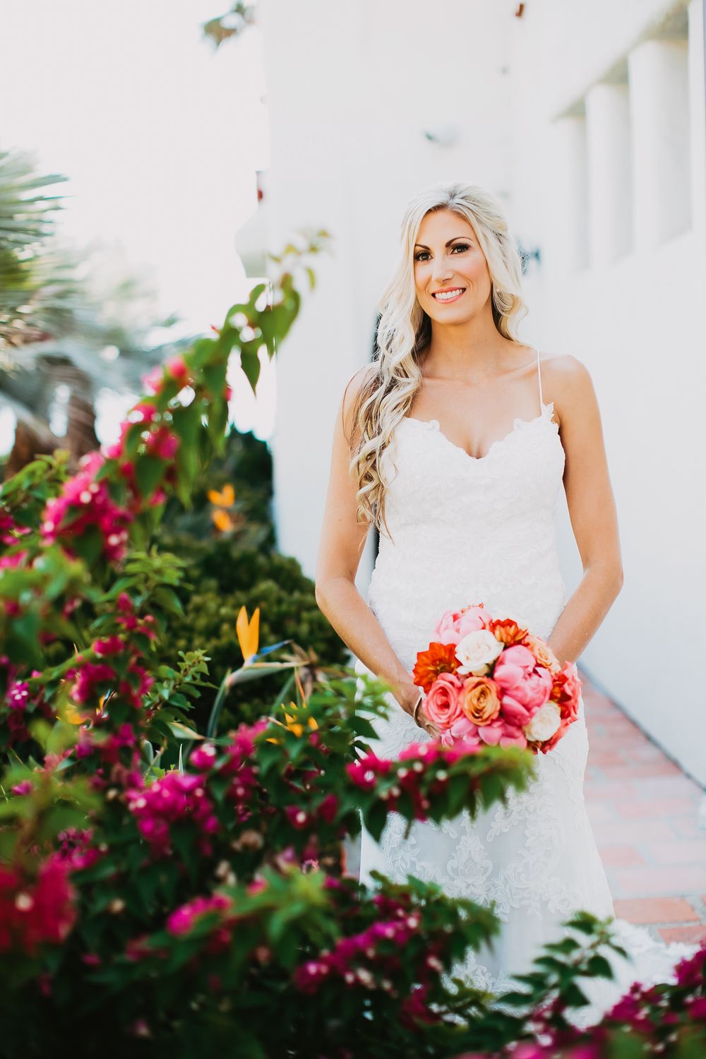 Bridal portrait sequence showing white lace wedding dress among vibrant pink bougainvillea flowers in outdoor setting.