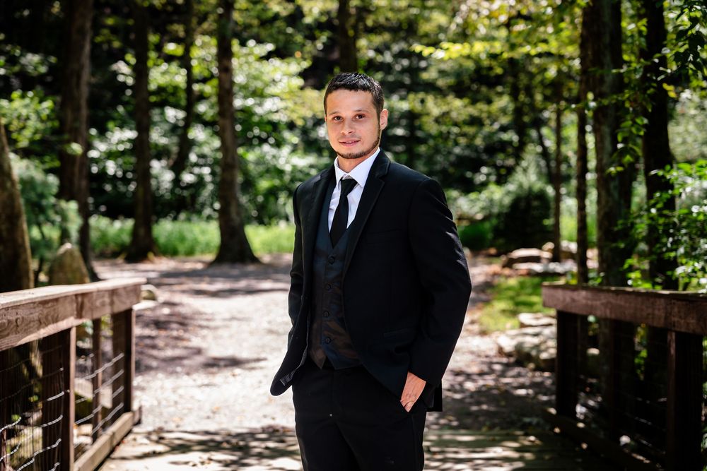 Formal portraits taken on wooded pathway with natural lighting.