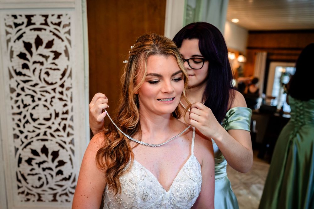 Wedding party preparations showing bridesmaids in a bright indoor setting.
