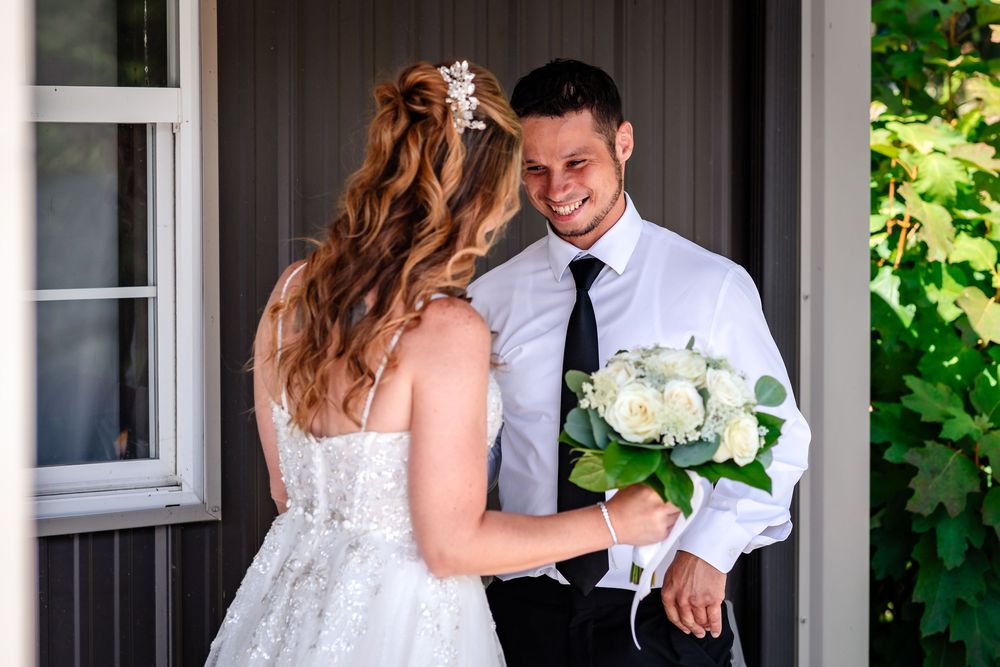 Candid moments captured during bride and groom's first look on wedding day.