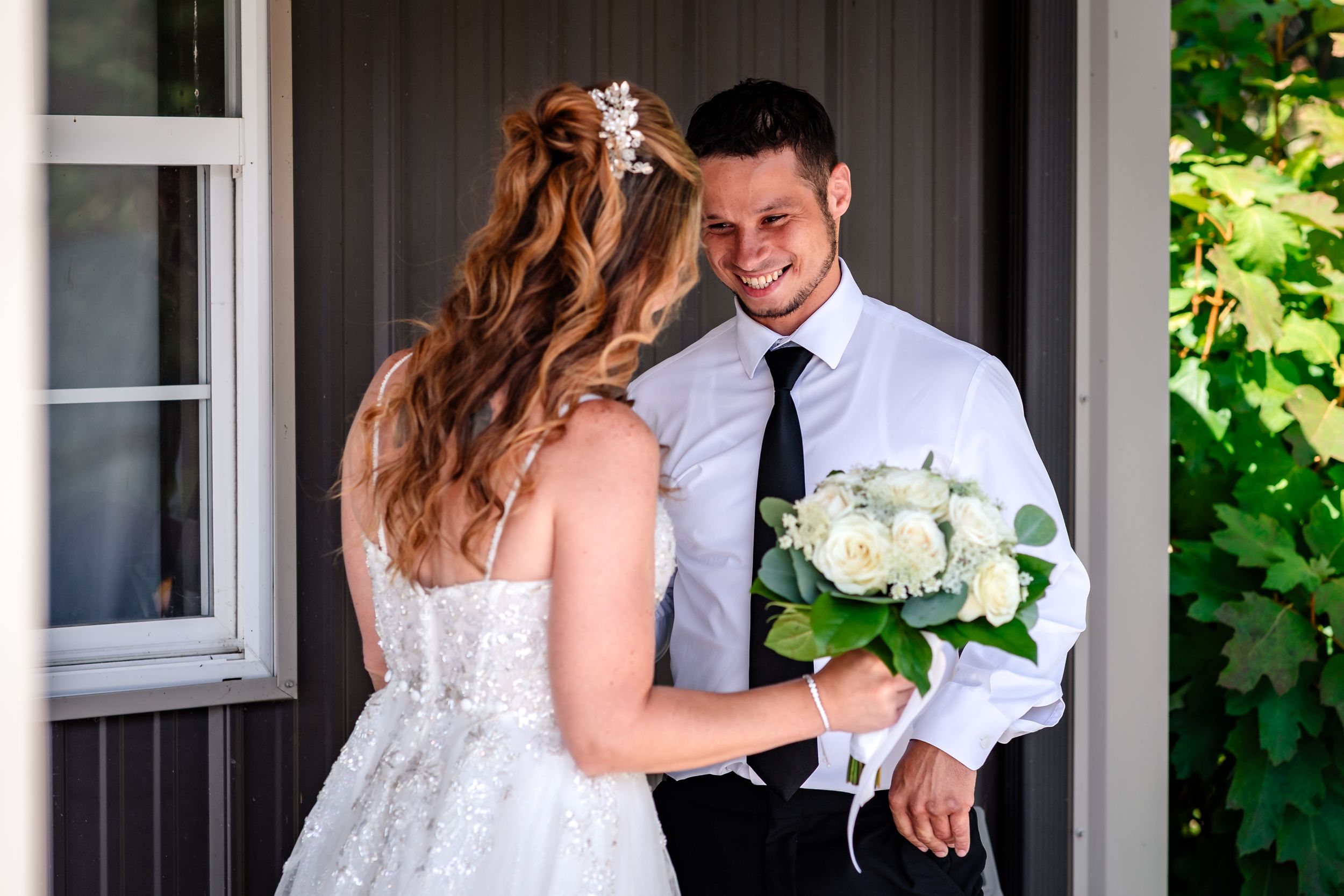 Candid moments captured during bride and groom's first look on wedding day.