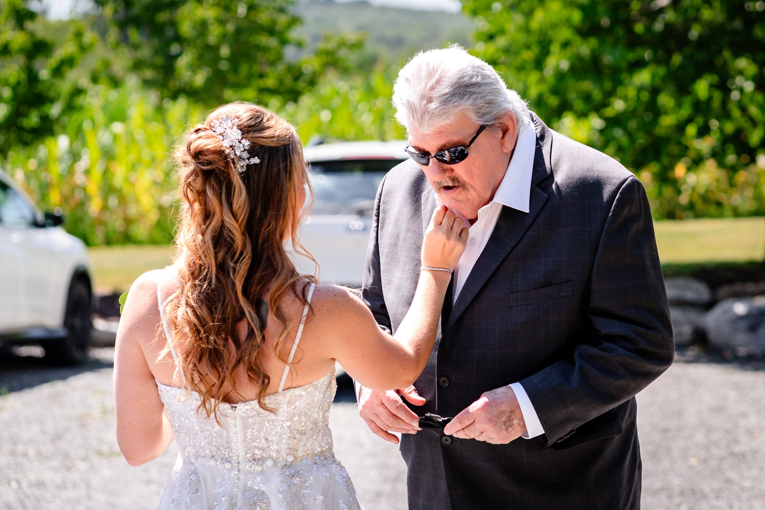Wedding party first look reactions captured in natural outdoor setting.