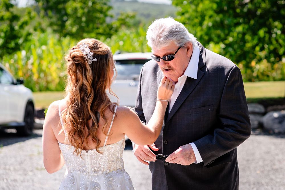 Wedding party first look reactions captured in natural outdoor setting.