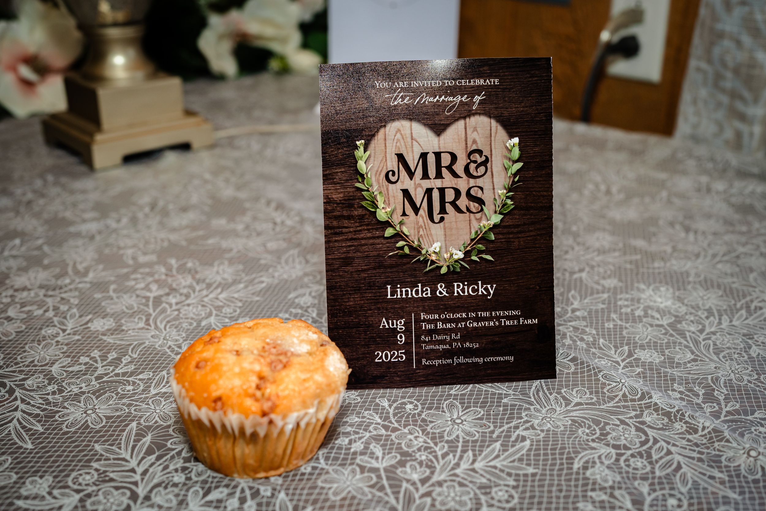 Wedding reception details including place cards and desserts on lace tablecloth.